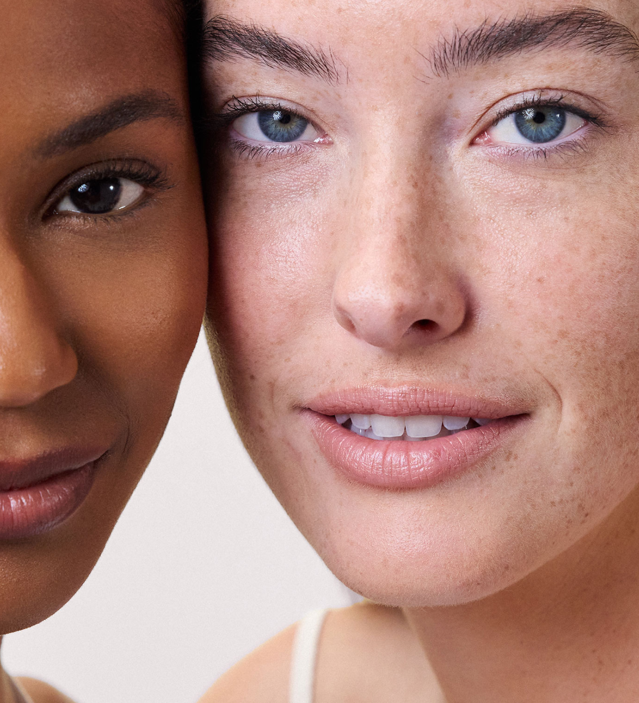 Two people with close-up faces are side by side, showing different skin tones and features in a neutral expression.