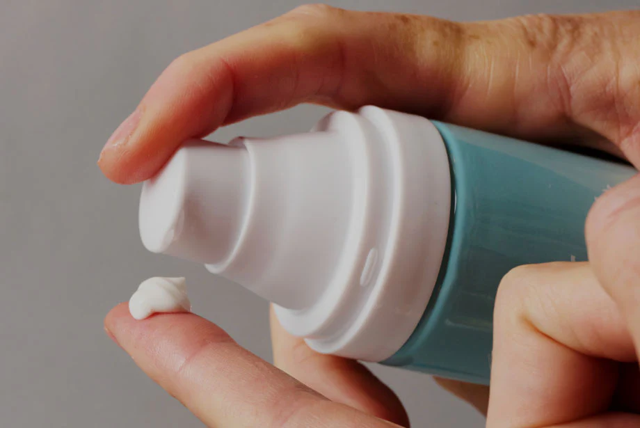 A person putting moisturizer on the skin for application