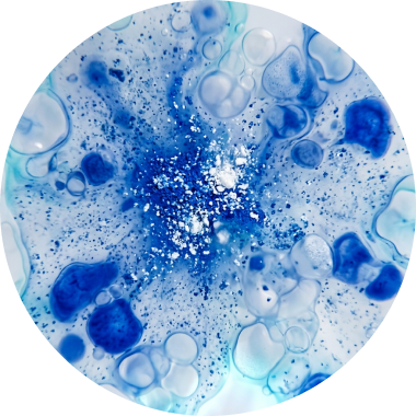 Circular abstract art featuring blue and white ink pigments swirling with bubble-like patterns.